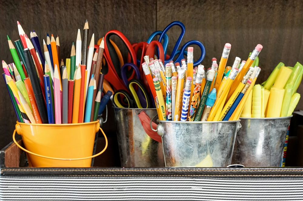 Buckets of pencils, scissors, and other classroom supplies